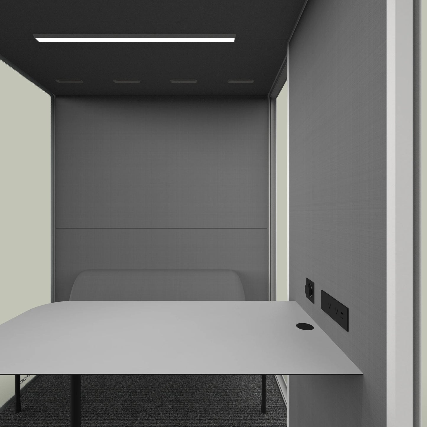 Modern office meeting pod with gray walls, minimalist desk, and power outlets.