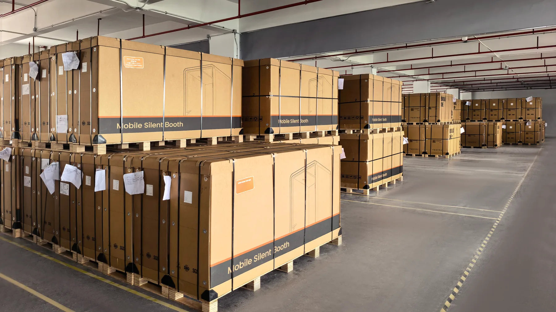 Finished PrivacyPod pods crated on pallets at the factory, ready to ship