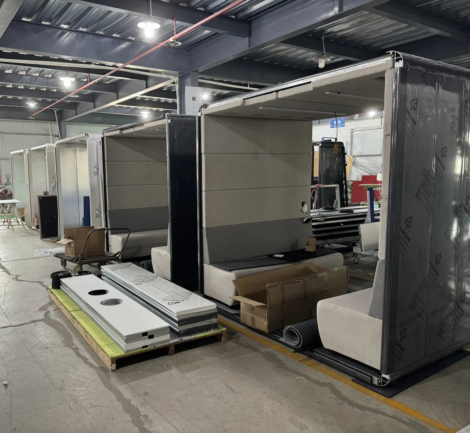 L Pod Plus office pods with bench seating in production on the factory floor