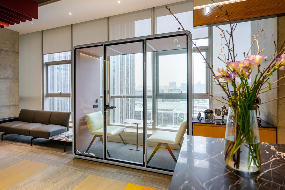 Glass-enclosed office pod in high-rise office