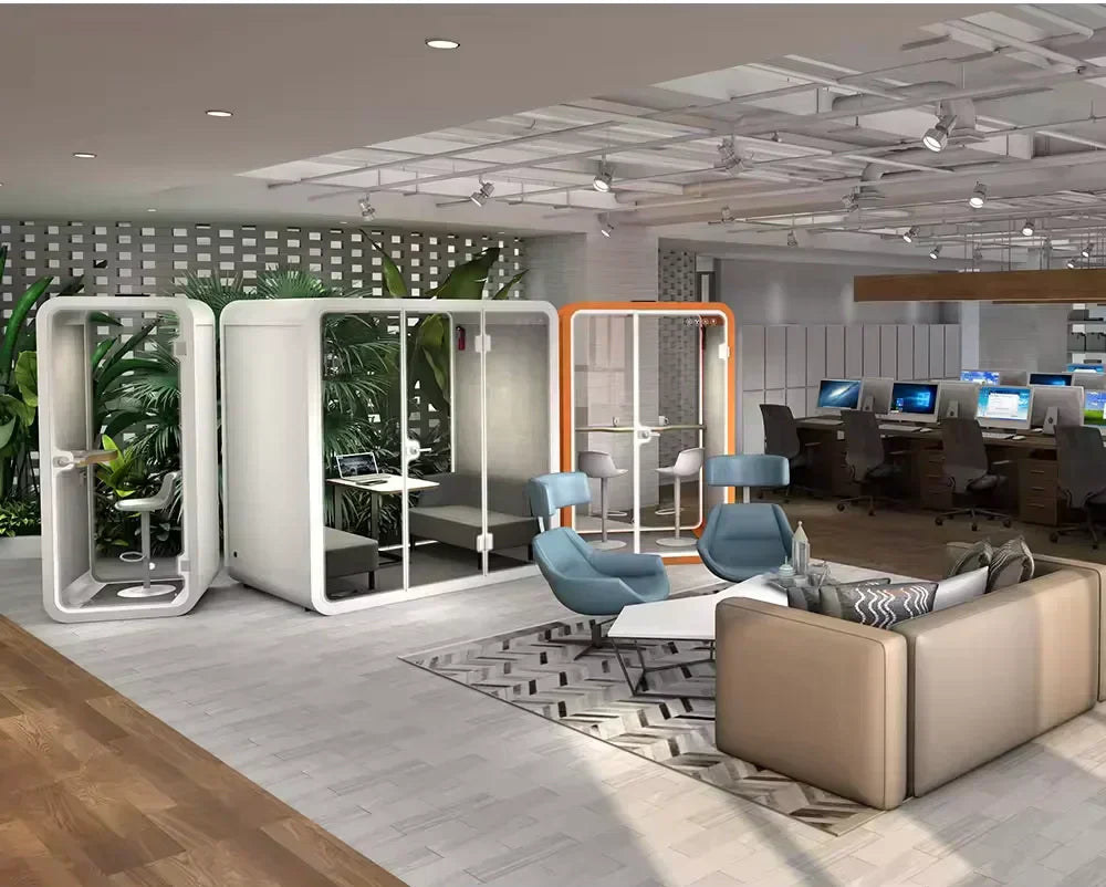 Modern office space with private pods, lounge area, and shared workstations