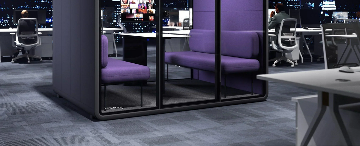 A modern workspace featuring PrivacyPod office pods, designed to support neurodiverse employees.