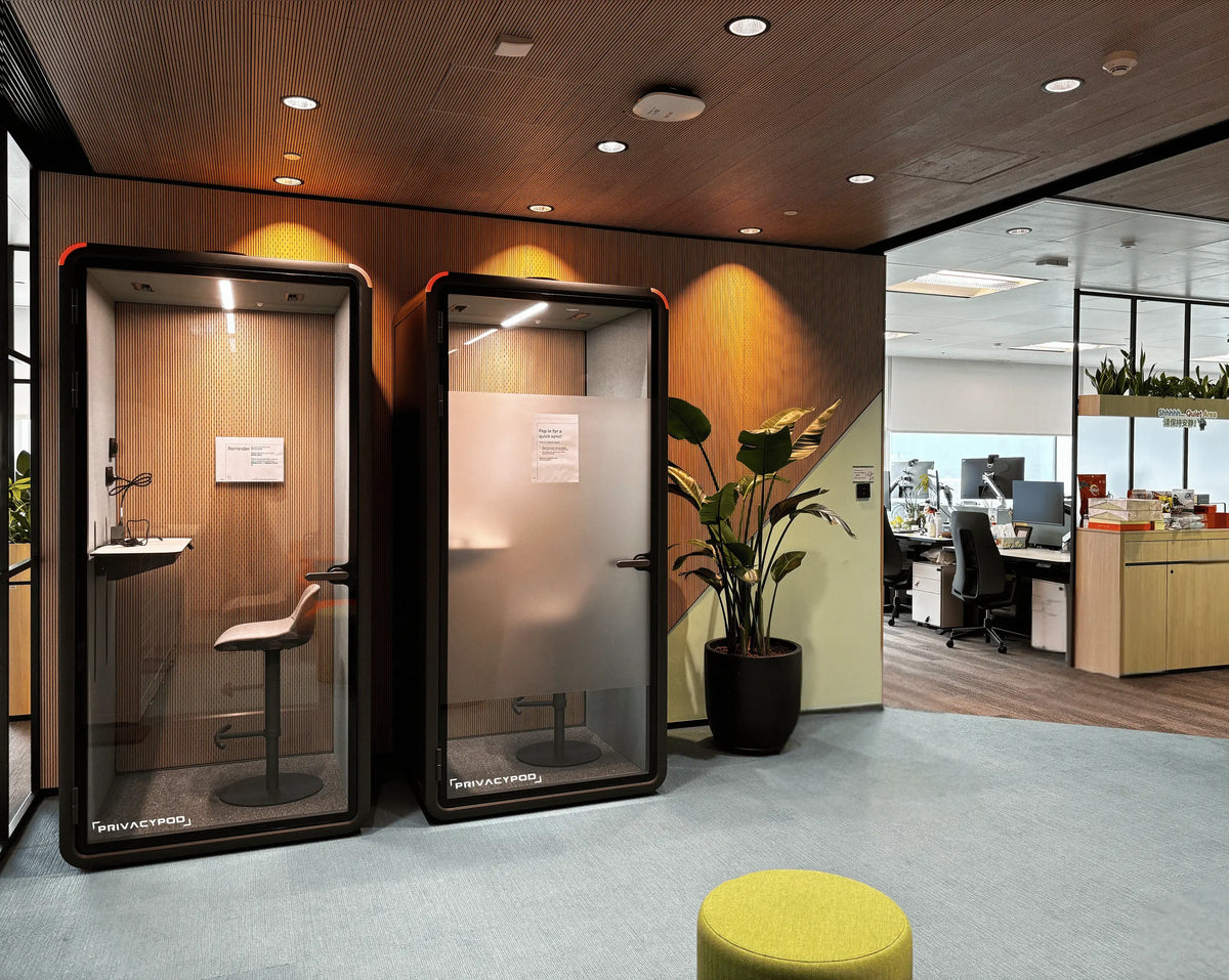 Modern office space featuring two office pods and an open workspace layout