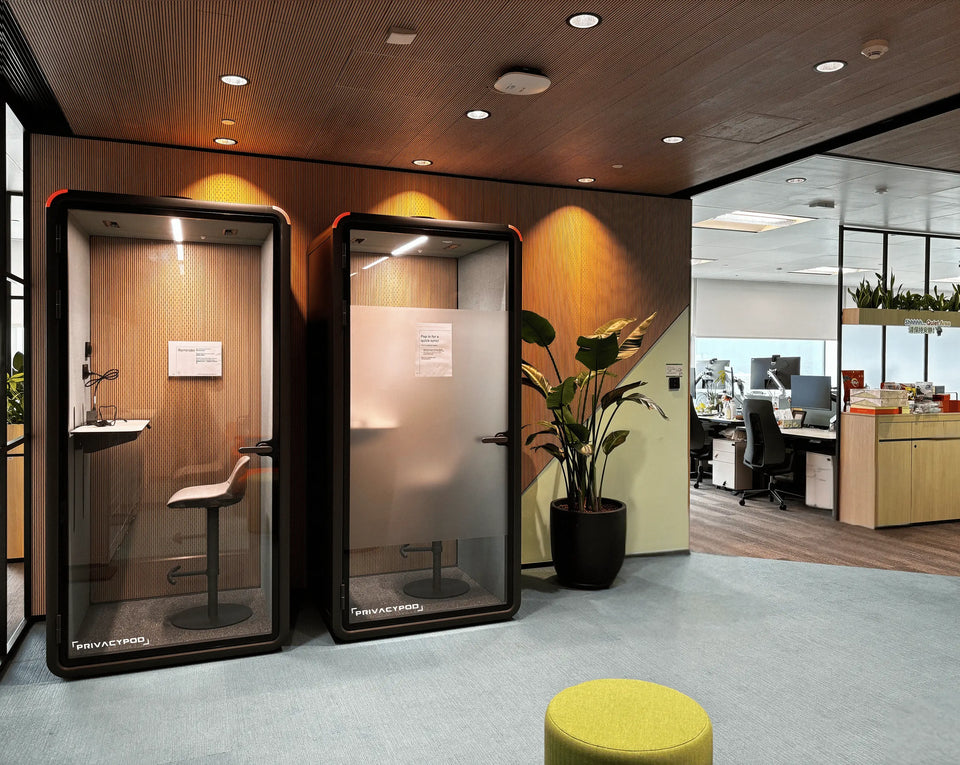 Modern office space featuring two office pods and an open workspace layout