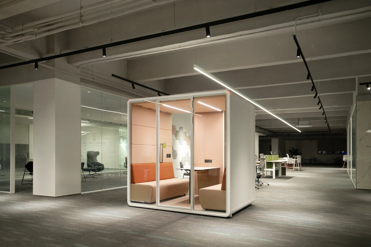 Orange office pod in the middle of open office
