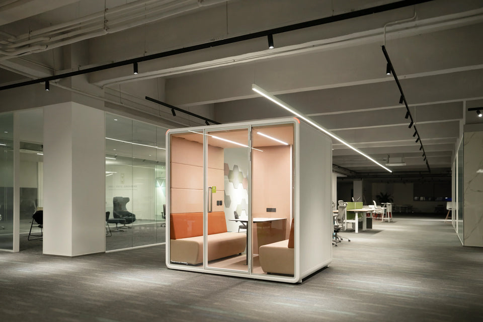 Orange office pod in the middle of open office