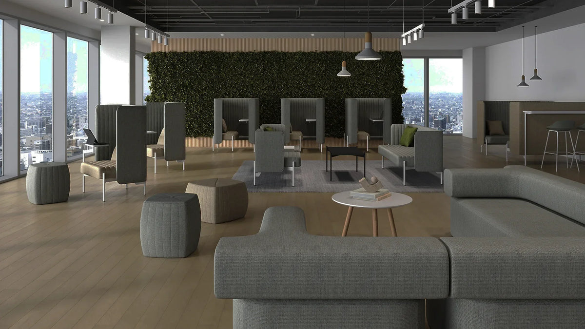 Modern office lounge with cozy seating and desktop cubicles.