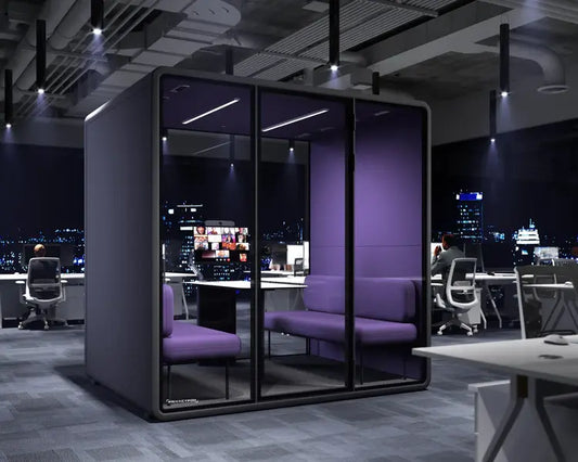 Modern glass-walled office pod with purple seating and night city view