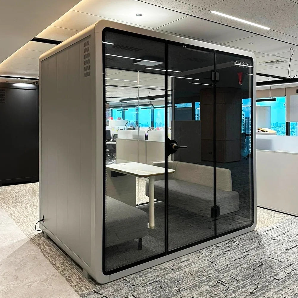 Bright and spacious PrivacyPod designed for four people, perfect for use as a soundproof office booth, privacy booth, or meeting room. This pod enhances office layouts by providing a quiet, distraction-free environment ideal for focused work and collaborative meetings.