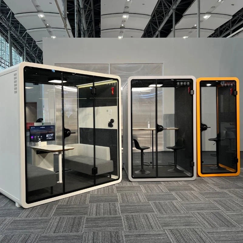 Collection of PrivacyPod office pods in varying sizes, perfect for use as meeting pods, phone booths, and zoom rooms. These soundproof office pods enhance workplace design by providing private, quiet spaces for focused work and meetings.