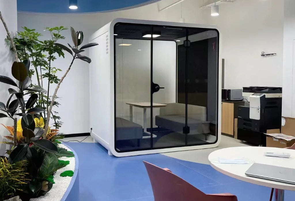 Bright and spacious PrivacyPod designed for four people, perfect for use as a soundproof office booth, privacy booth, or meeting room. This pod enhances office layouts by providing a quiet, distraction-free environment ideal for focused work and collaborative meetings.