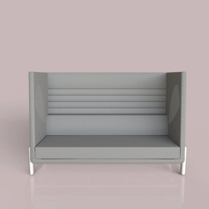 Modern gray sofa with high backrest and side panels, set against a pastel pink background.