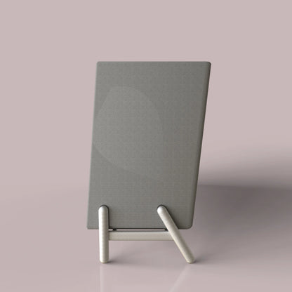 Minimalist gray fabric acoustic panel on a sleek metal stand against a soft pink background.