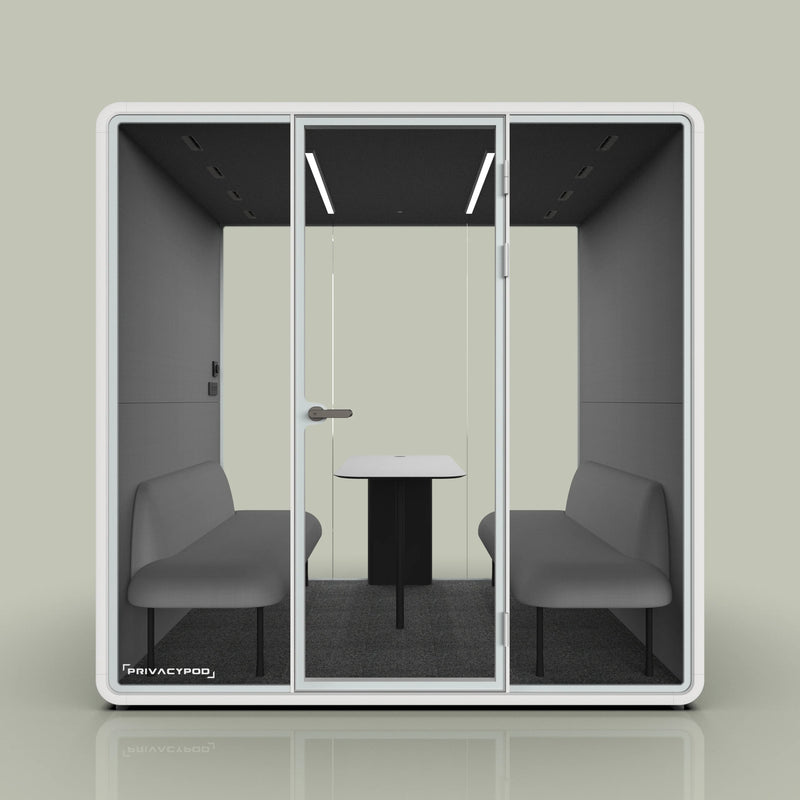 Modern privacy pod for office meetings with glass doors, gray seating, and a central white table, designed for soundproof discussions.