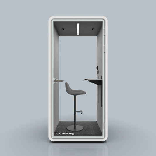 Soundproof privacy pod featuring a minimalist design with a stool and a ...