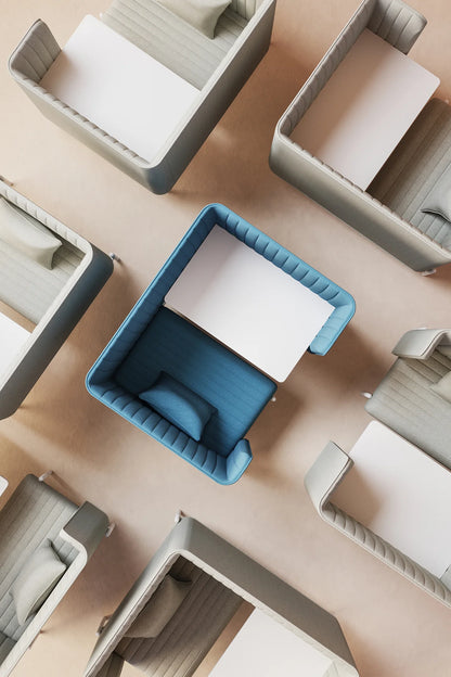 Modern office workspace design with blue and grey cubicles, featuring integrated desks and cushioned seating, viewed from above.
