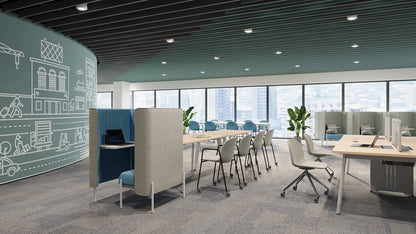 Modern open office space with workstations, ergonomic chairs, and a large window view of a city skyline.