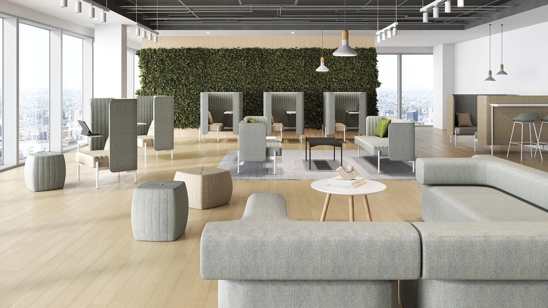 Modern office lounge with modular seating, green wall decor, wooden flooring, and panoramic city views through large windows.