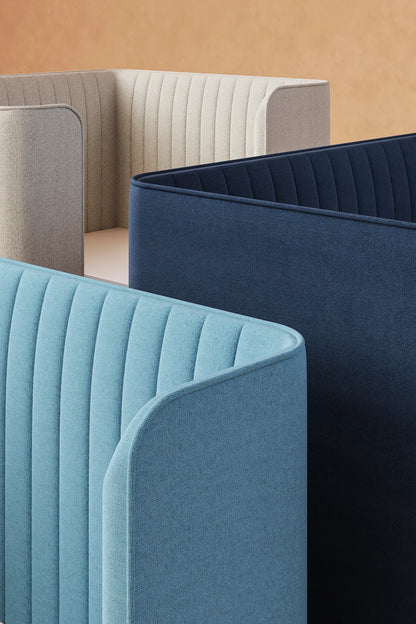 Modern modular seating with curved backs in beige, blue, and navy fabrics against a neutral background.