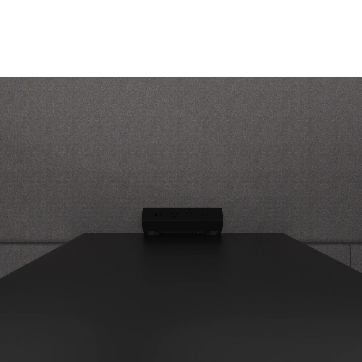 Close-up of the Quad Meeting Nook power module on the table top: two US outlets, USB-A and USB-C against the rear panel
