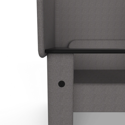 Close-up of the Solo Wing Chair side panel: a round US outlet set into the fabric under the tablet arm